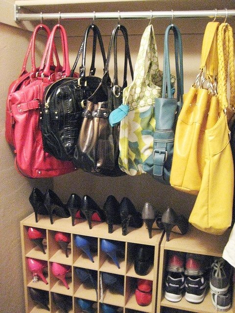 Shower hooks for purse storage ... genius! Seems more practical than shower rings since you don't have to unclasp the ring every time you want to use a purse.