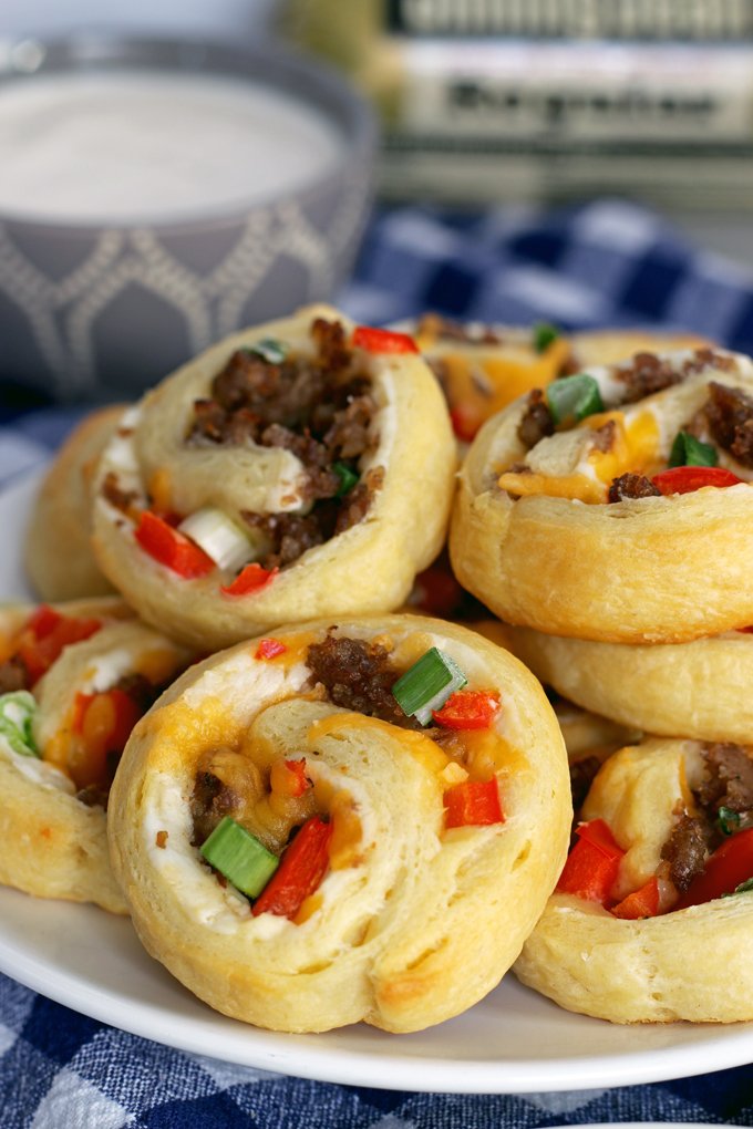 If you're looking for game day food, this sausage pinwheel appetizer is going to be your new favorite recipe for tailgating season. It's made with ®Jimmy Dean Sausage, refrigerated crescent rolls, red bell peppers and two types of cheese;it's an easy and delicious appetizer to add to your party. Just serve it with a little ranch! | honeyandbirch.com