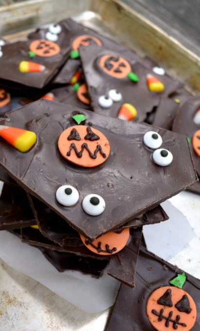 This simple chocolate Halloween bark takes a simple treat to the next level with spooky pumpkins, candy corn, and glaring eyeballs- it's sure to be a hit with your favorite ghosts and ghouls this holiday!